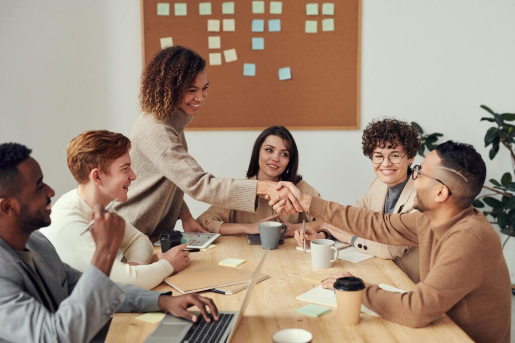 Two individual in a meeting shaking hands