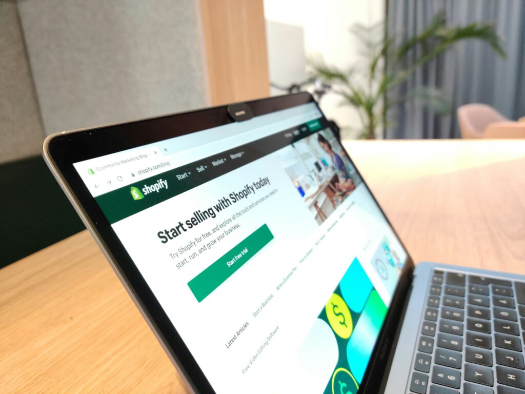 Laptop on top of a table showing the Shopify store