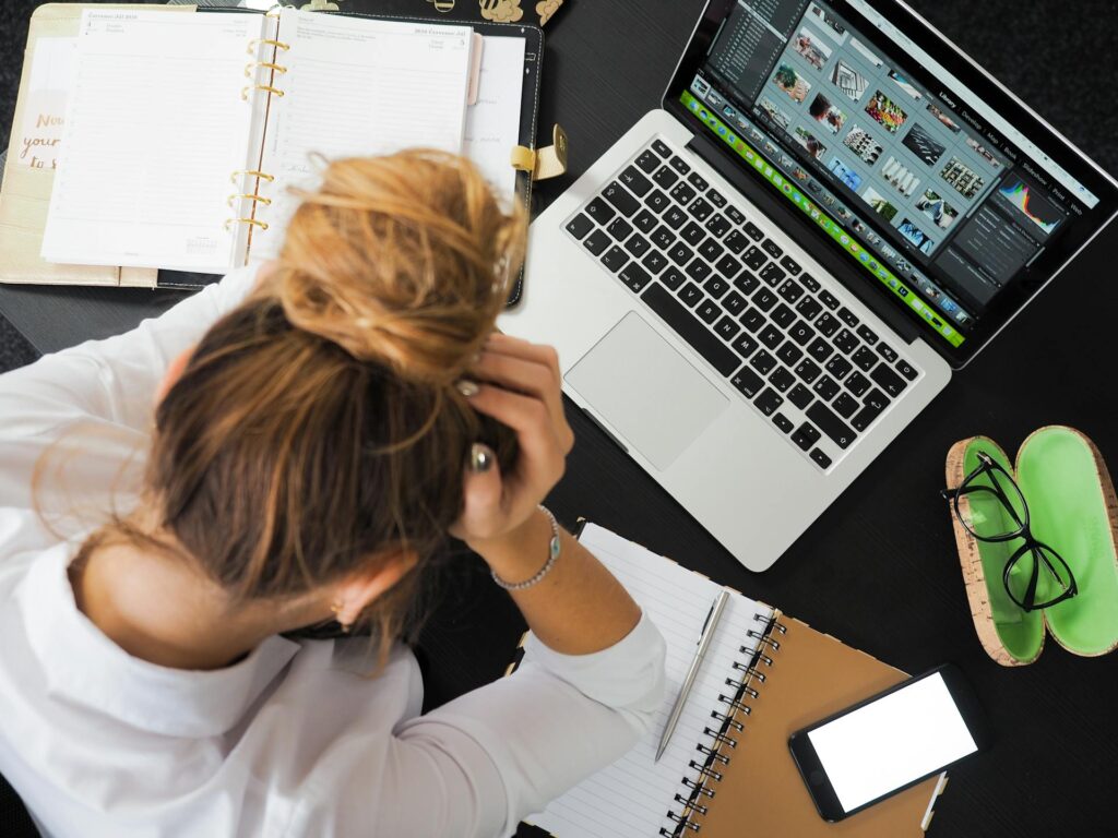 A woman infornt of her laptop thinking about Common Mistakes to Avoid