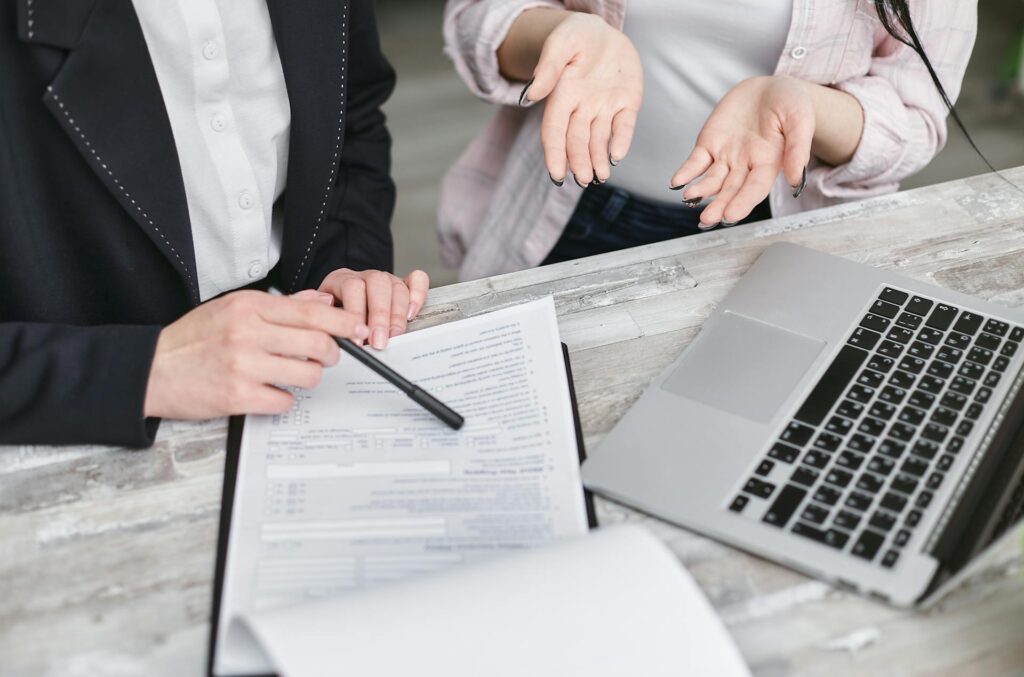 Two workers dicussing legal compliance on a piece of document