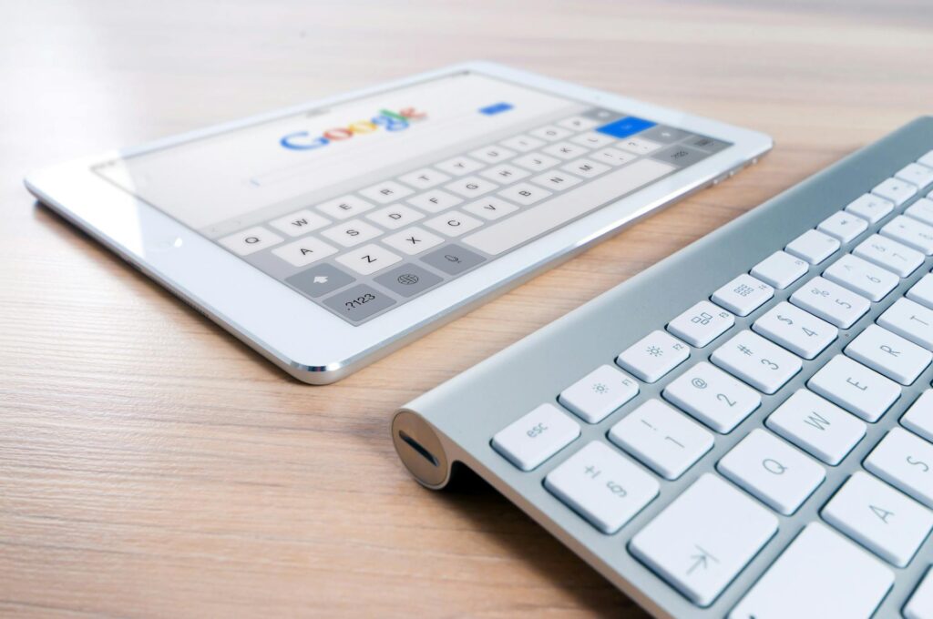 A white tablet and a computer keyboard