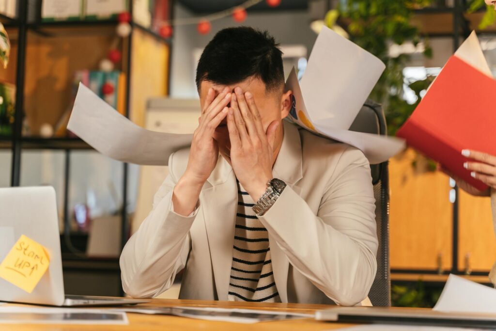 Office worker stressed infront of his laptop
