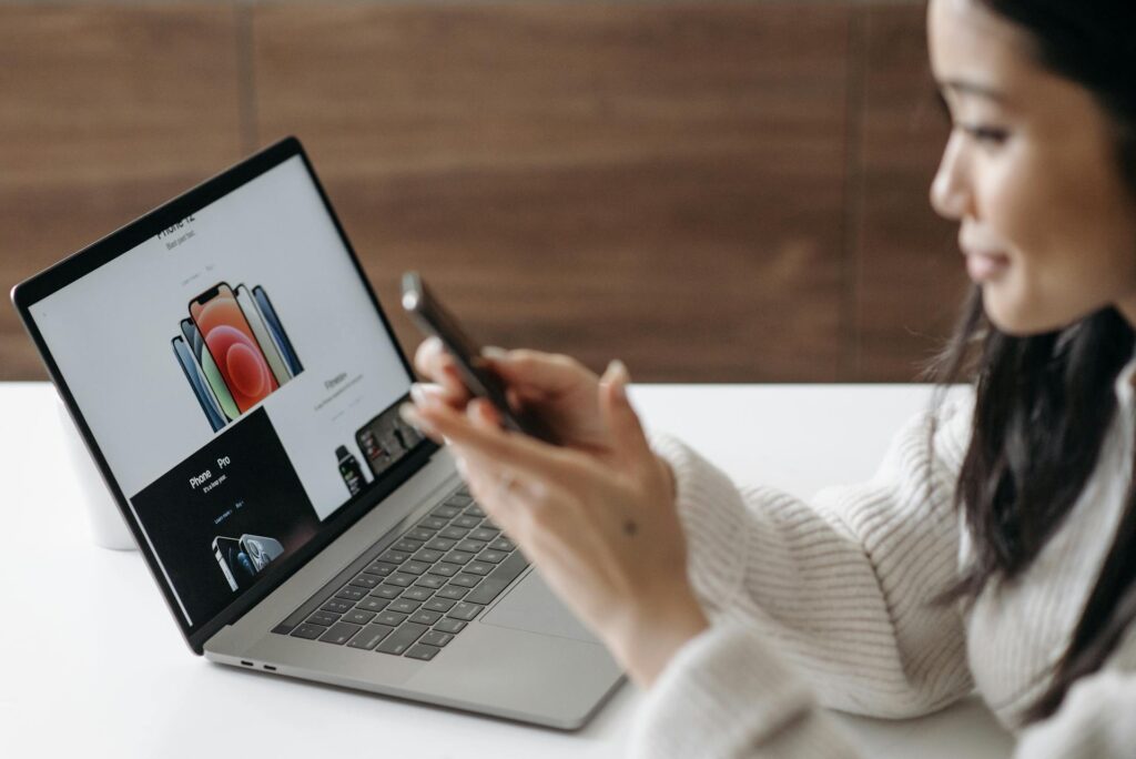 Woman buying a phone online using her laptop
